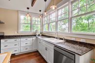 White Wooden Kitchen Cabinet Near Window