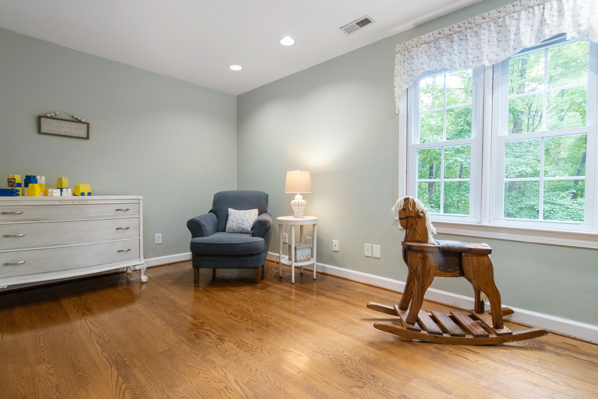 Inviting living room featuring a classic wooden rocking horse and elegant decor.
