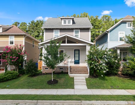 A beautiful suburban home with a well-maintained lawn and vibrant surroundings.