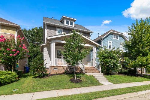 Free Beautiful suburban home with lush greenery and clear blue sky. Stock Photo