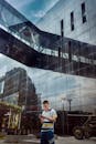 Man Walking by Glass Building