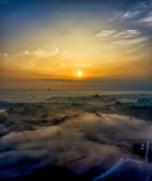 Free A breathtaking aerial view of a foggy Indonesian landscape during sunset, capturing serene beauty. Stock Photo