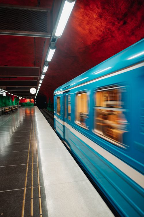 Free A vibrant blue train speeds through Solna Centrum station in Stockholm, Sweden. Stock Photo
