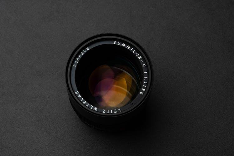 Modern Photo Camera Lens On Black Table