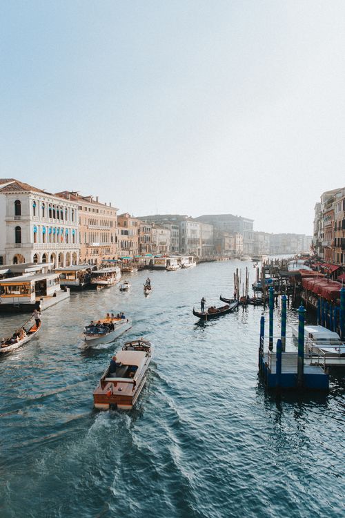 Free Explore the vibrant Grand Canal in Venice with iconic gondolas navigating serenely. Stock Photo
