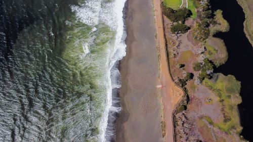 Free Stunning aerial shot of Pacifica Beach, California, with waves crashing onto the shore. Stock Photo