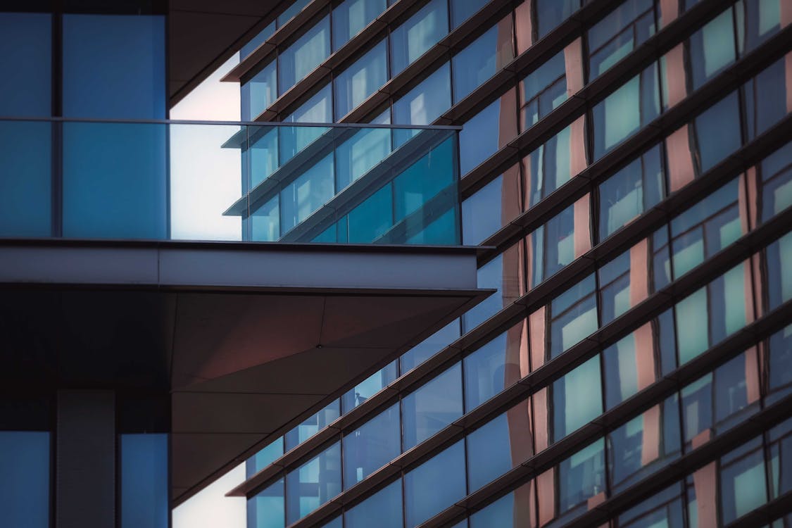 Free Low Angle Exterior Of Modern Multi Storey Glass Buildings In Residential City District In Daylight Stock Photo