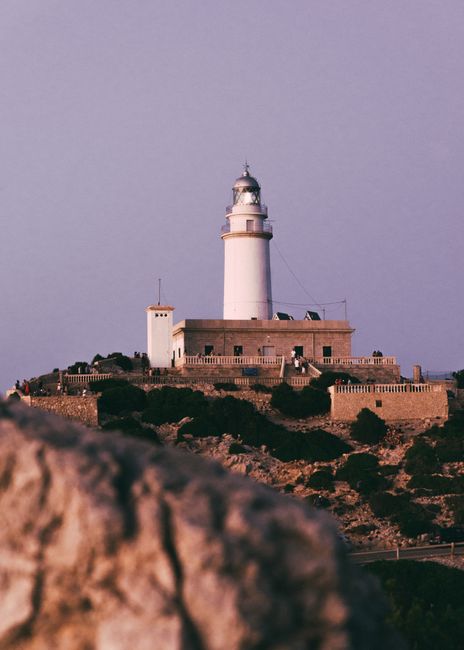 Serene sunset view of Cap de Formentor Lighthouse in Pollença, Majorca, Spain.