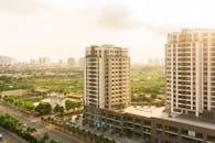 High Angle Shot of Buildings Near Grass Field