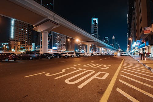 Free Cars Parked along the Street in Modern Downtown at Night  Stock Photo