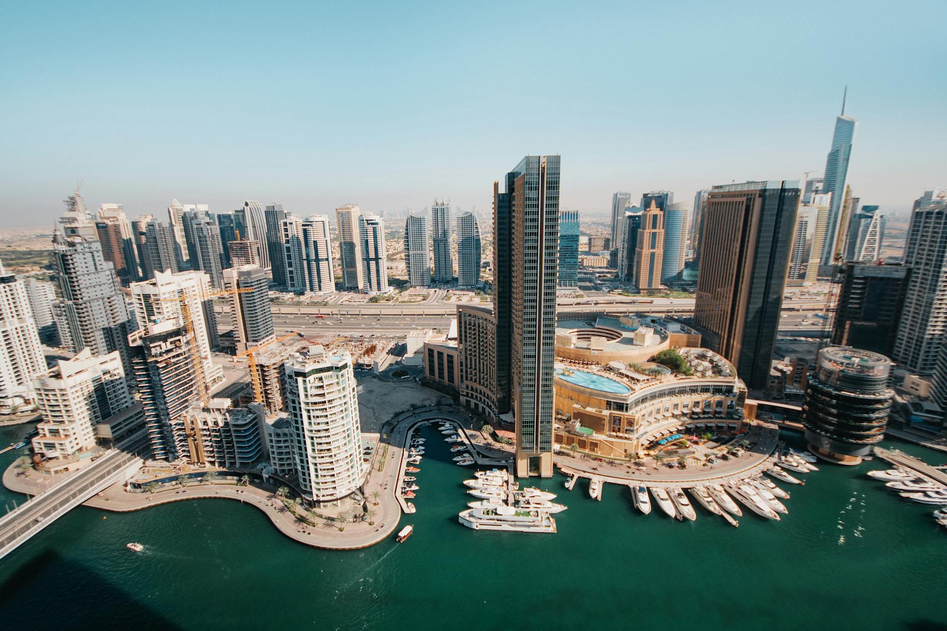 Stunning aerial view of the vibrant modern Dubai Marina skyline with waterfront and skyscrapers.