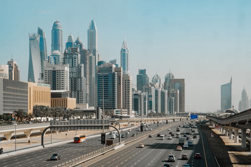 Free Aerial view of Dubai's skyline with bustling highways showcasing modern architecture. Stock Photo