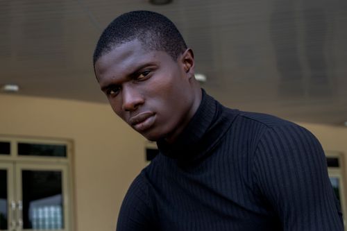Free A focused portrait of a man indoors wearing a black sweater in Nigeria. Stock Photo