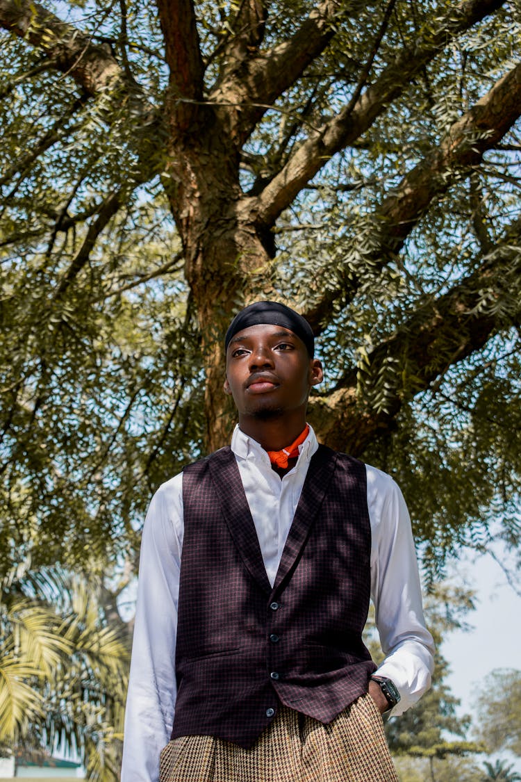 Elegant Man Standing In Shade Under Tree 