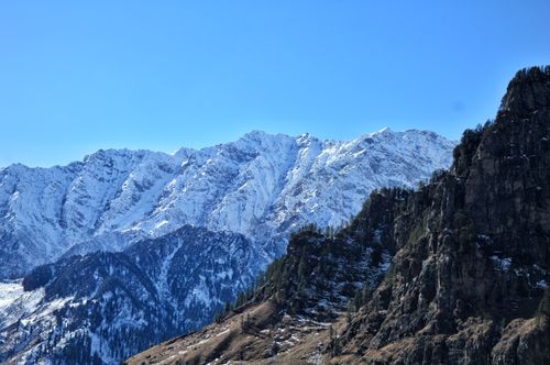 Free Breathtaking view of snow-capped mountains and clear blue sky in India, showcasing natural beauty and serenity. Stock Photo