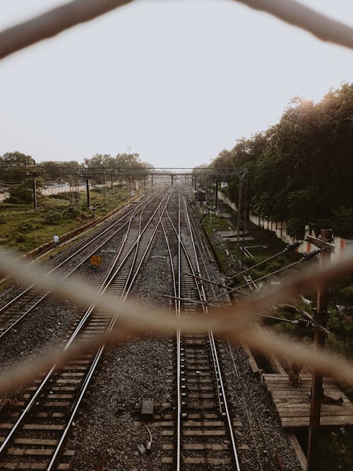 Railway Tracks Seen through Steel Barrier