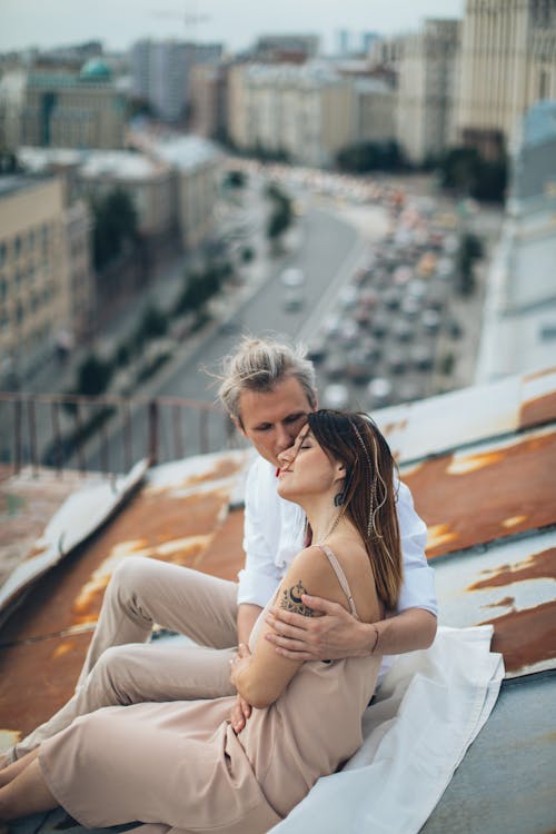 Free Man and Woman laying on the Roof Stock Photo
