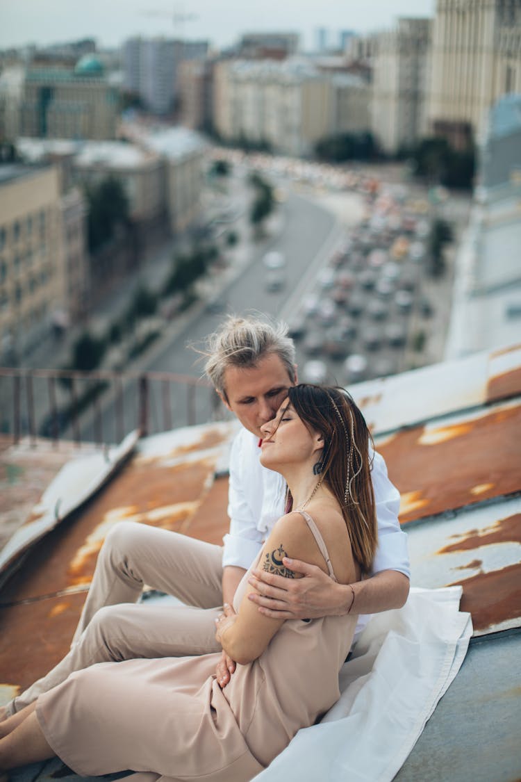 Man And Woman Laying On The Roof