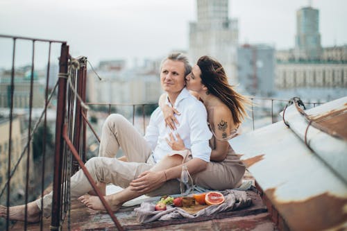 Happy couple having picnic on rooftop