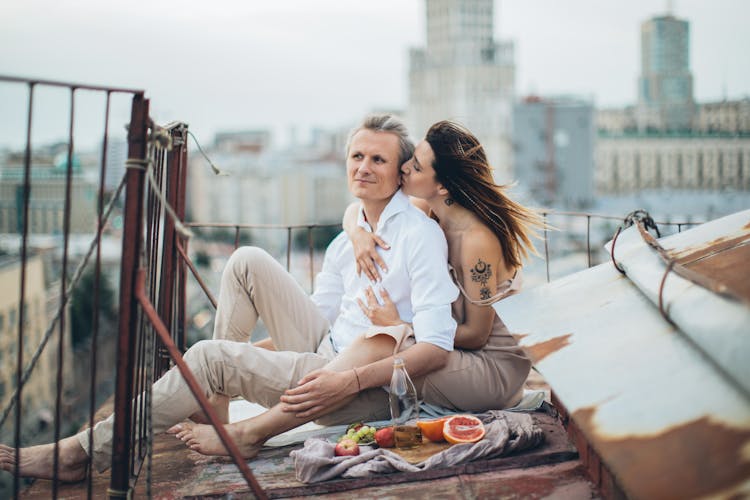 Happy Couple Having Picnic On Rooftop