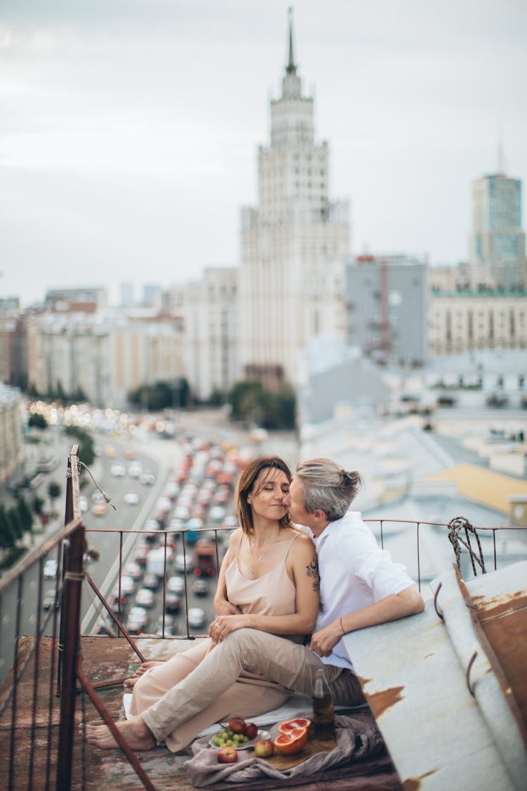 A Couple Having A Date On A Rooftop With A View Of The City Of Moscow