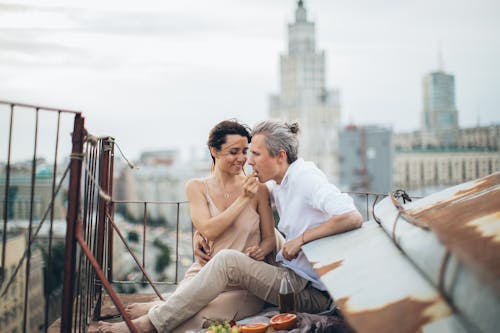 Happy couple having picnic on rooftop
