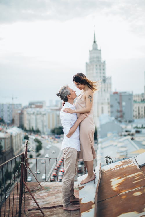 Loving couple embracing on rooftop in city