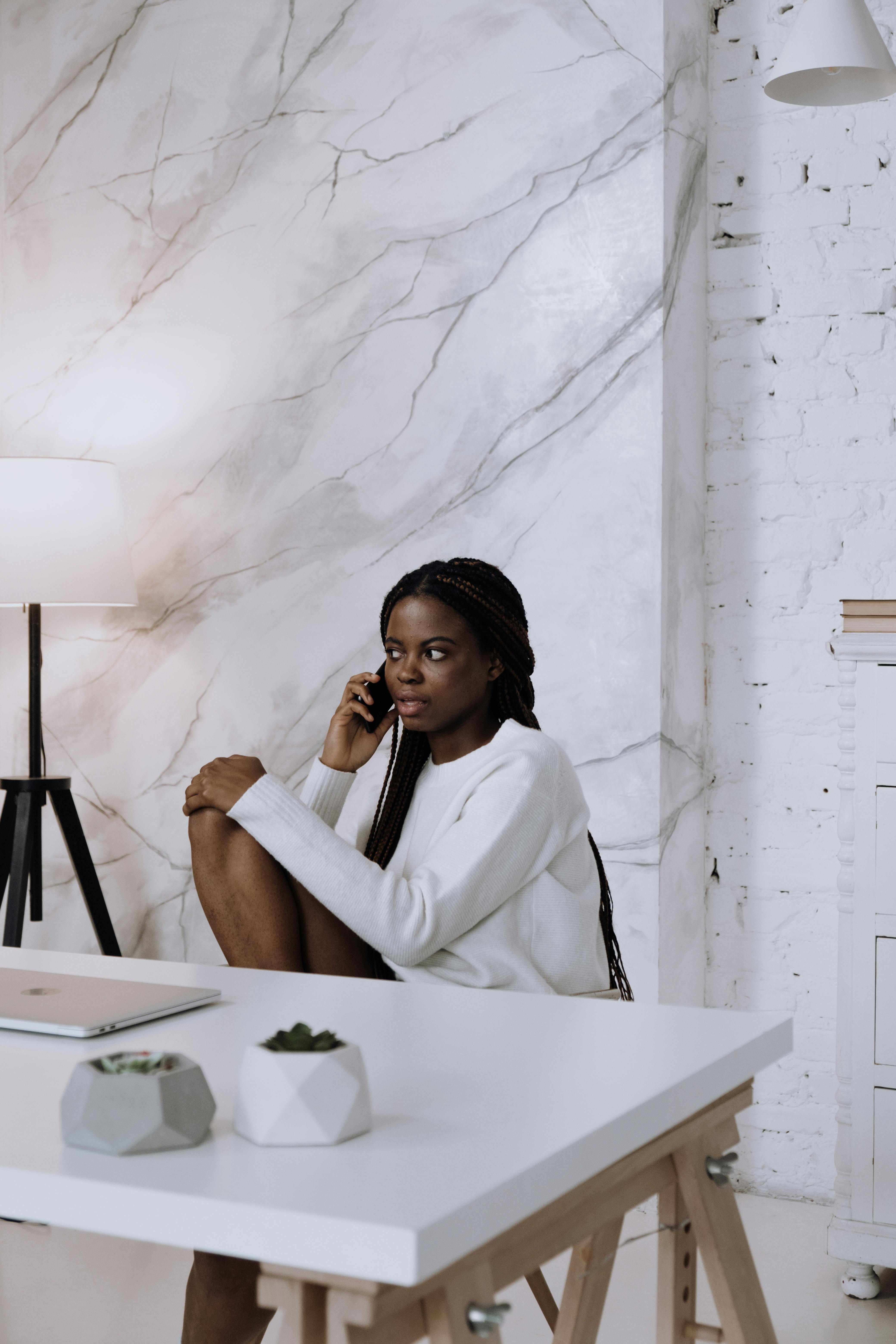 woman in white dress shirt sitting on chair