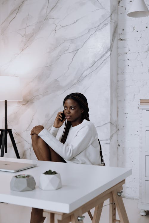 Woman in White Dress Shirt Sitting on Chair