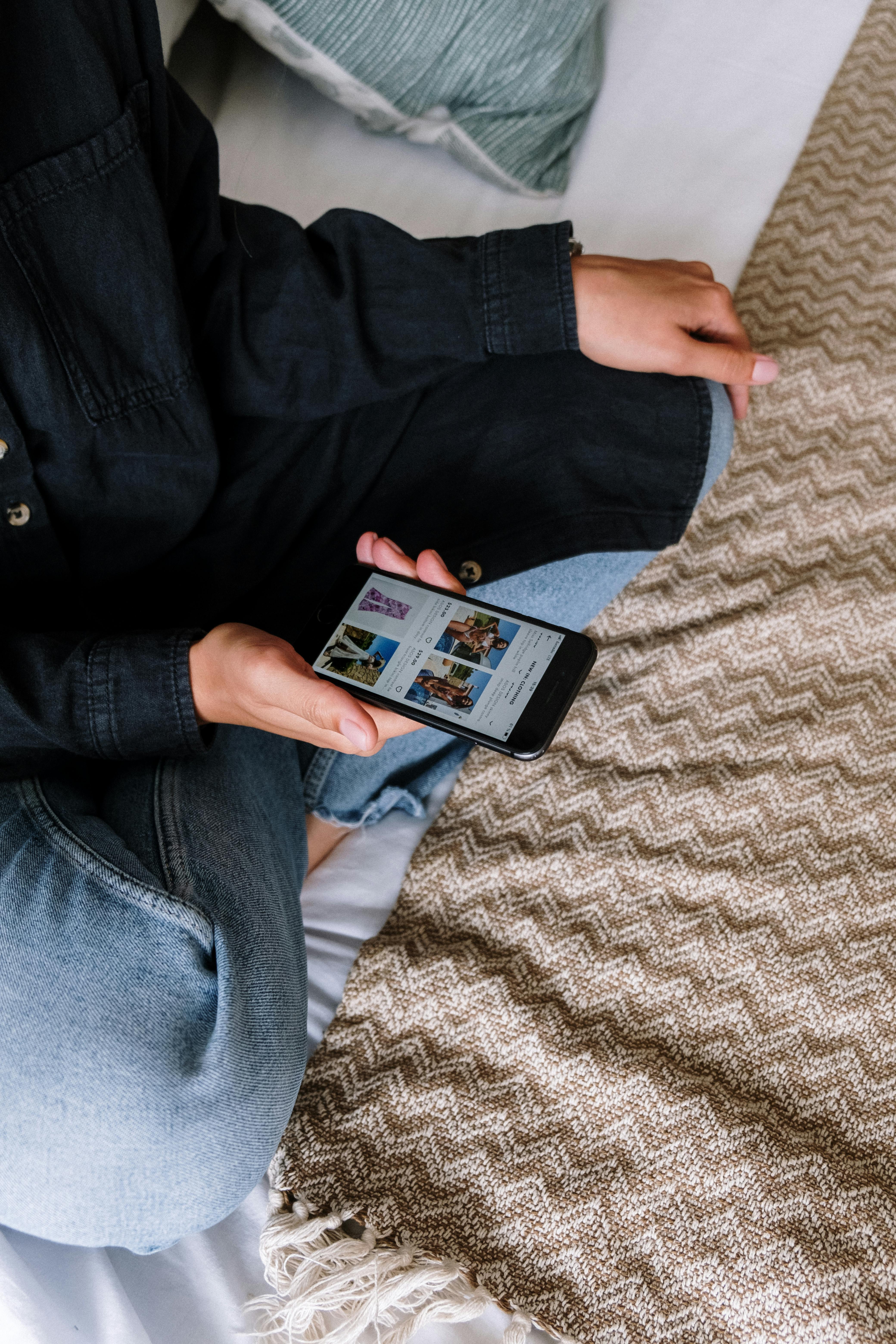 Person in Black Jacket Holding Black Android Smartphone · Free Stock Photo