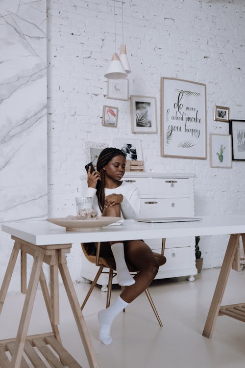 Woman in White Shirt Sitting on Chair