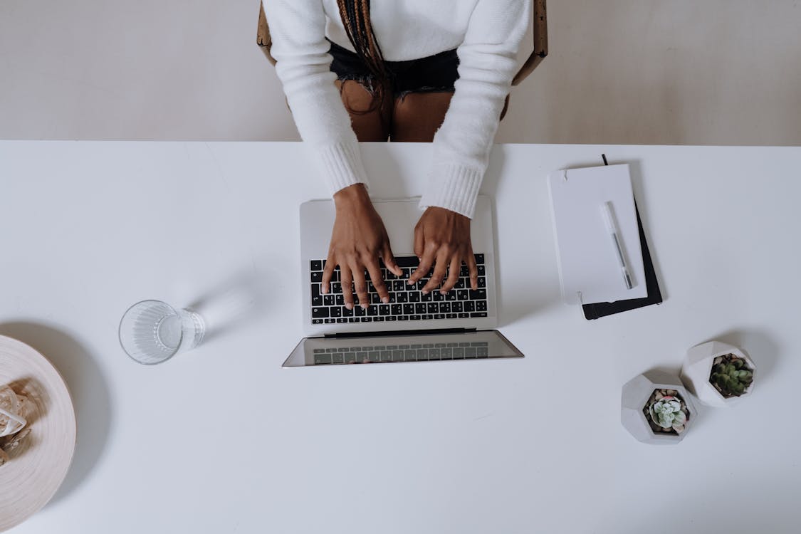 Free Woman in White Long Sleeve Shirt Using Macbook Pro Stock Photo