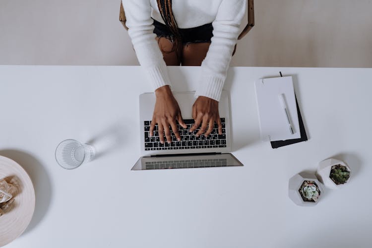 Woman In White Long Sleeve Shirt Using Macbook Pro