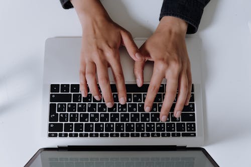 Free Persons Hand on Silver and Black Laptop Computer Stock Photo