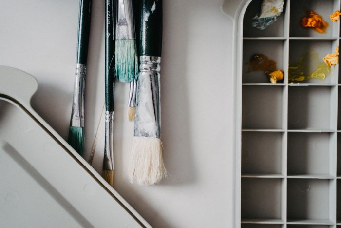 Brushes laid beside a palette