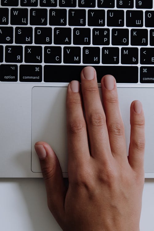 Free Persons Hand on Macbook Stock Photo