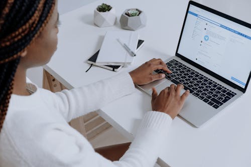 Free Person in White Long Sleeve Shirt Using Macbook Air Stock Photo