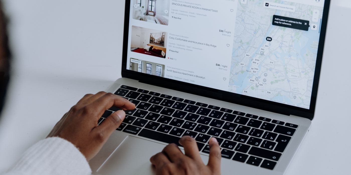 A person comparing hotel prices on a laptop with a credit card in hand in 2026