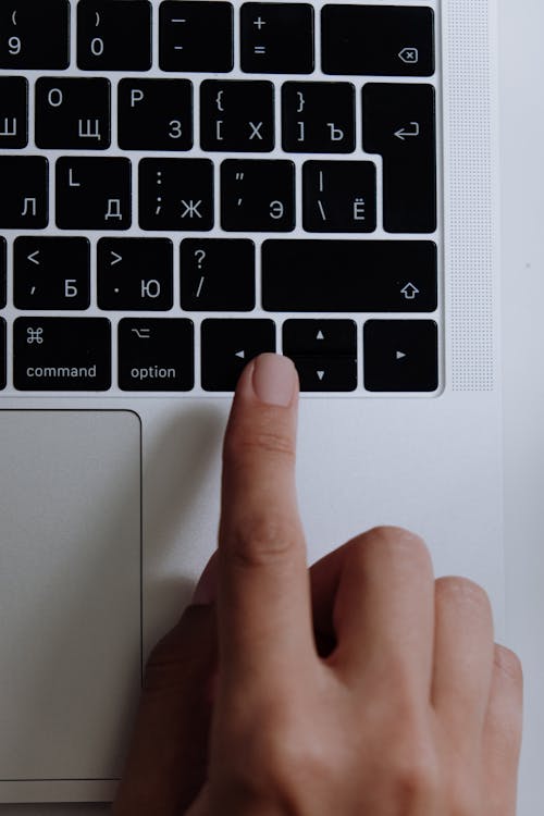 Persons Hand on Macbook