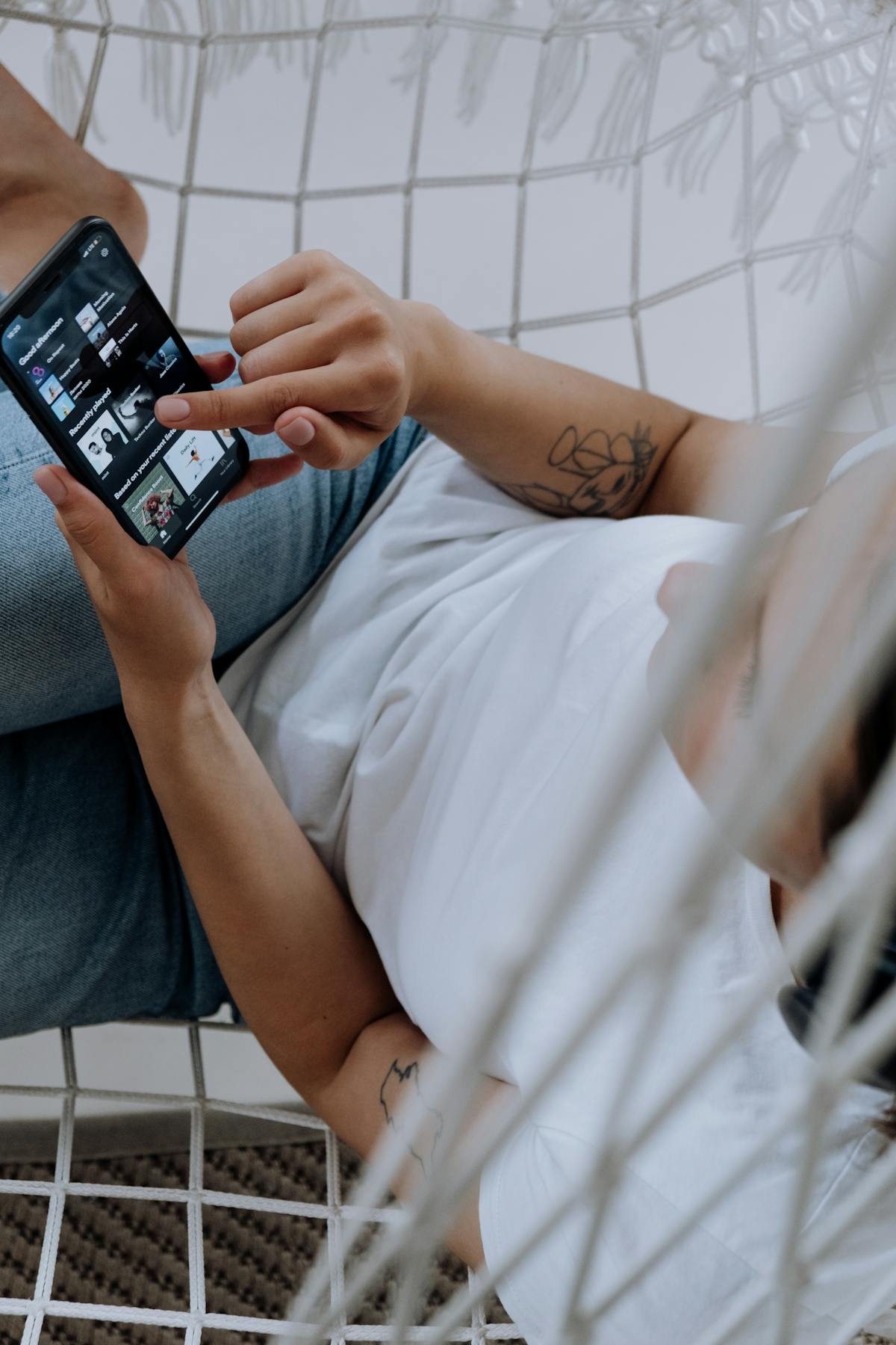 Person listening to music on a smartphone using headphones