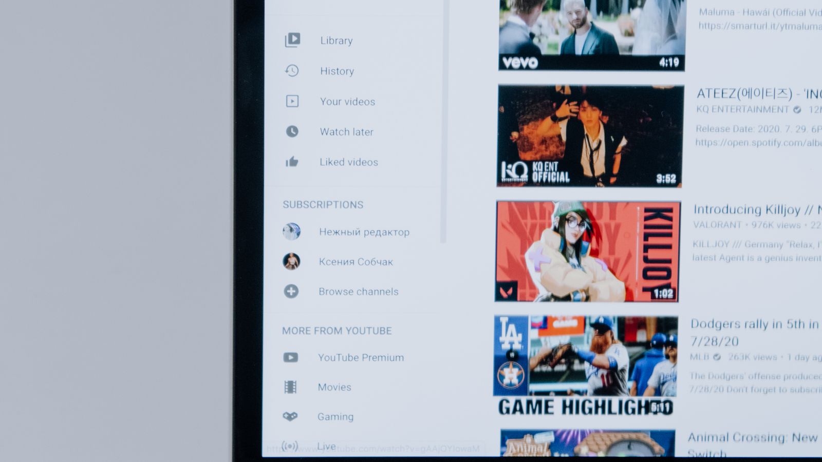 Laptop showing an online video browsing interface on a desk