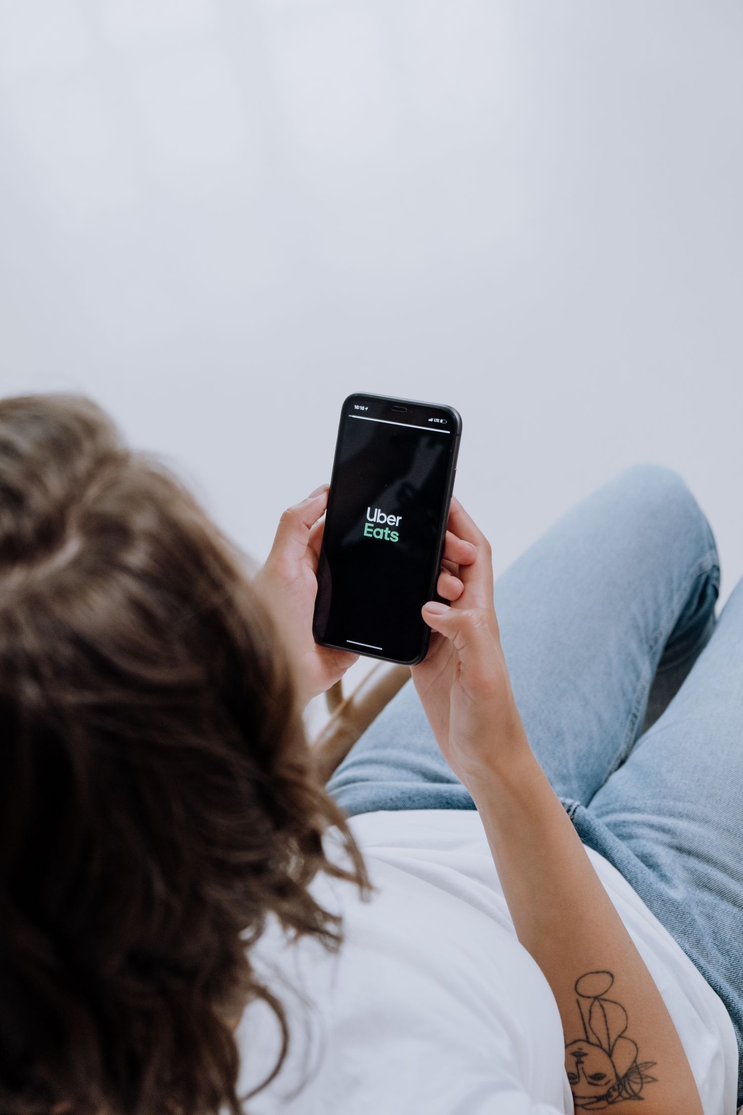 Person opening a ride booking application on a smartphone screen