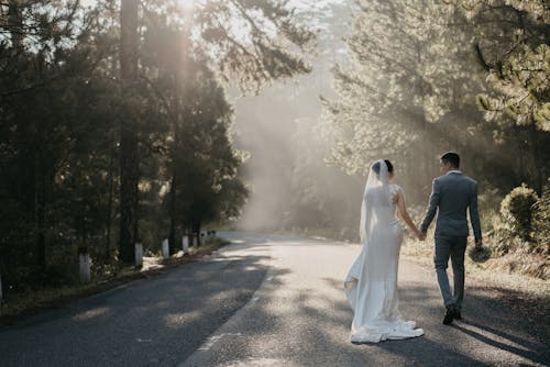 Free Man and Woman Walking on Road Stock Photo