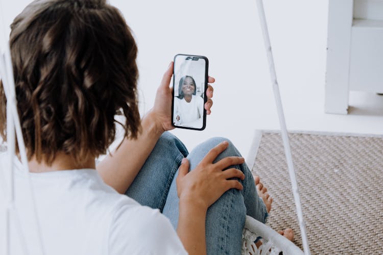 Woman In White Shirt Holding Iphone 6