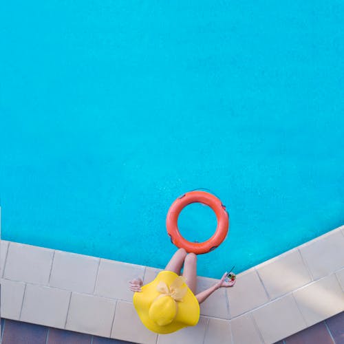 A Woman Sitting by the Swimming Pool