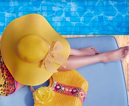 Woman Sitting on Side of Swimming Pool