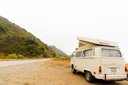 Free A classic Westfalia campervan parked on a scenic mountain road, perfect for adventure travel. Stock Photo