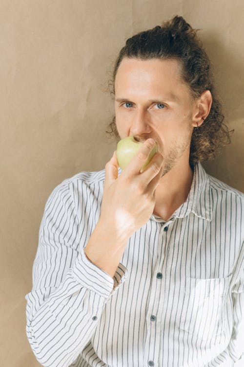 Free Man Eating Green Apple Stock Photo