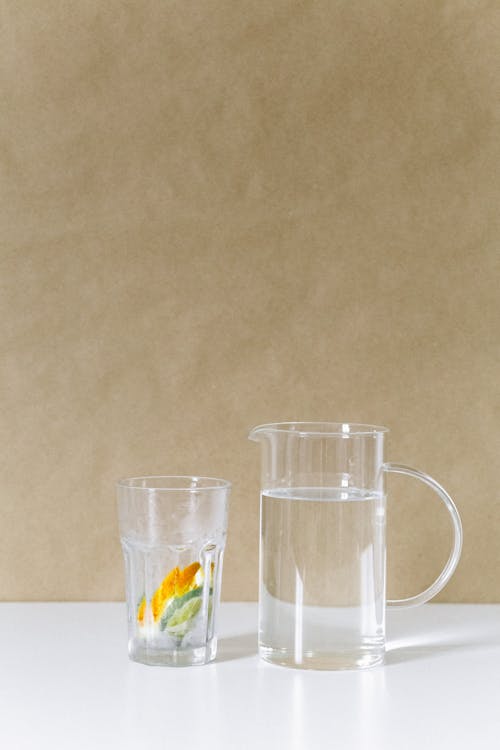 Free Liquid in the Glass Pitcher Near the Drinking Glass Stock Photo