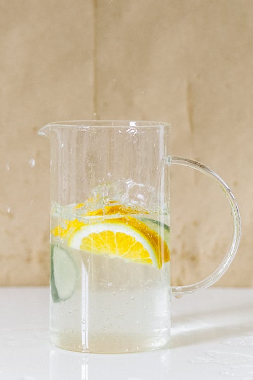 Clear Glass Pitcher With Water and Lemon Slice